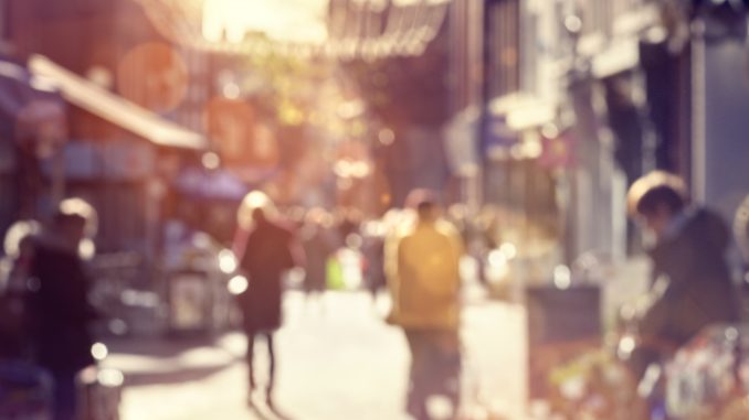 Crowd of shoppers walking and shopping on a high street